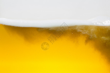 啤酒泡沫波金色啤酒杯玻璃泡沫王冠喷洒酒精图片