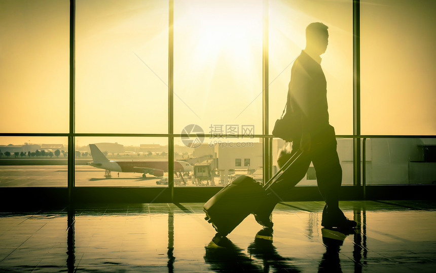 阳光直射，机场男乘客走进现代生活图片