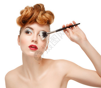 化妆品化妆品漂亮的女人用化妆刷的美丽肖图片
