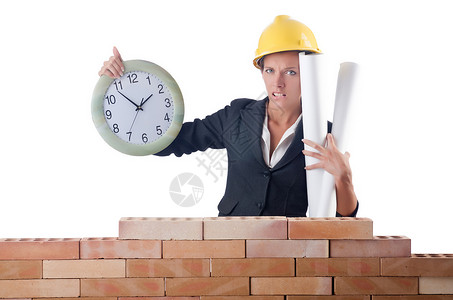 白色时钟的女建筑工人图片