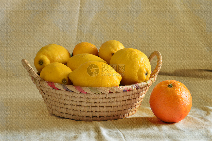有柠檬和一个橙子的篮子图片