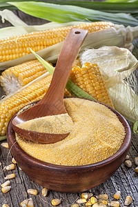 旧木桌上木碗里的玉米糁玉米粥背景图片
