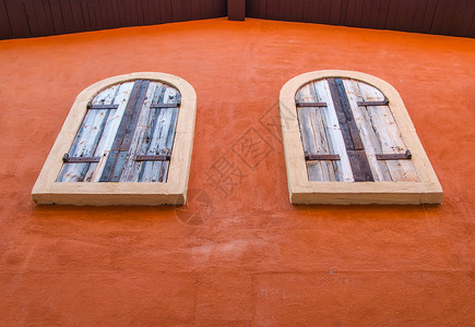 橙色水泥墙上的老式窗户图片