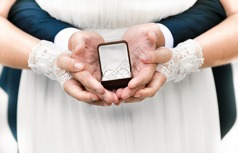 新娘和新郎用结婚戒指拿着开箱装结图片