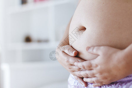 孕妇用手摸肚子背景图片