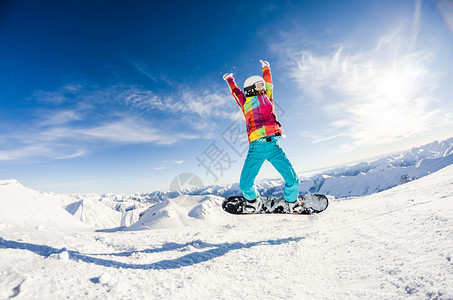 女孩在她的滑雪板跳跃中玩得开心图片