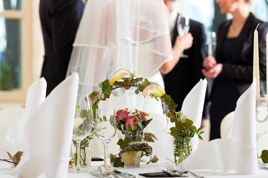 在用鲜花装饰的婚宴上的婚桌图片