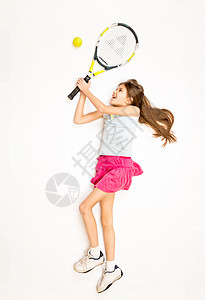 快乐女孩躺在地板上以拍打网球的电击游图片