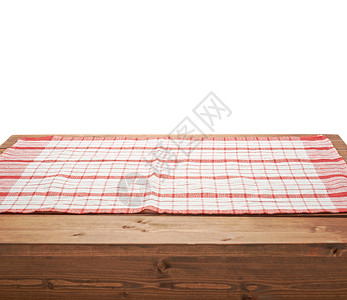 棕色木制桌板表面的红桌布或毛巾白色背景背景图片