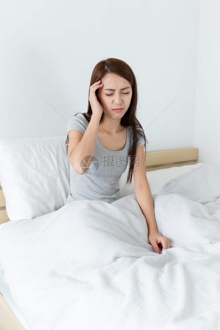 床上的亚裔少妇头疼图片