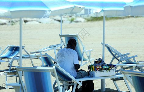 夏天在沙滩上遮阳伞下的非洲卖家图片