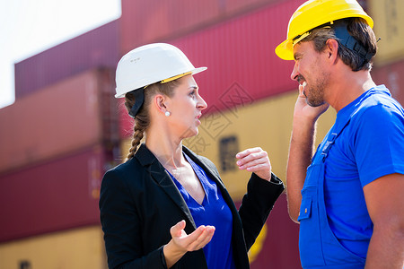港口集装箱码头的货运工人和经理商讨论货运问题图片