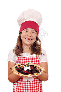 快乐的小女孩做饭小厨师抱着塞图片