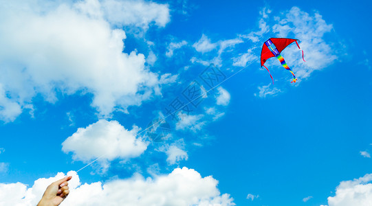 在云端的天空中手持风筝图片