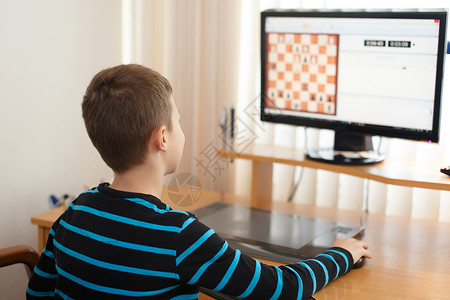 小男孩玩网上象棋家里的图片