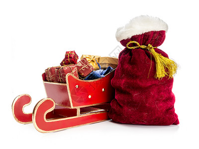 红雪橇满的圣诞礼物和圣诞老人包图片