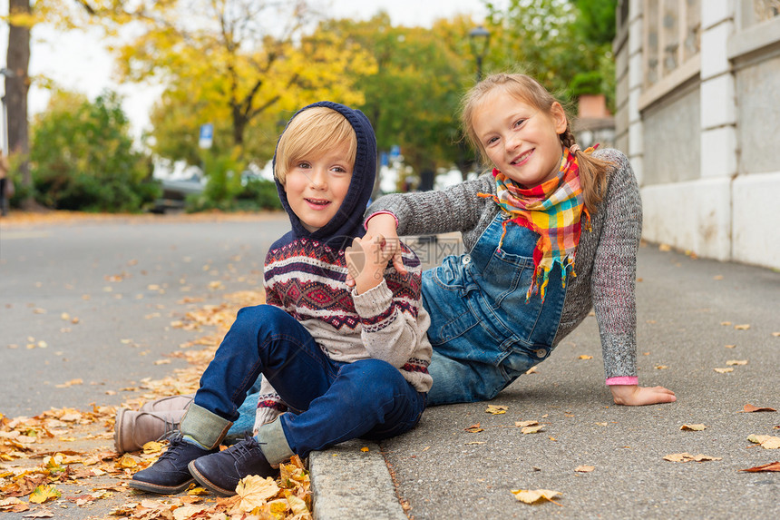 城市里两个可爱孩子的秋天肖像穿着暖身图片