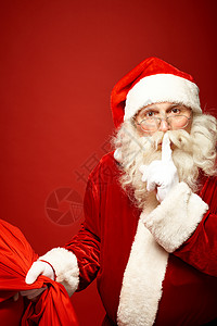 圣诞老人拿着圣诞礼物的麻袋嘴里图片