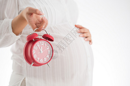计算期待孩子出生的时间母概念孕妇拿着闹钟图片