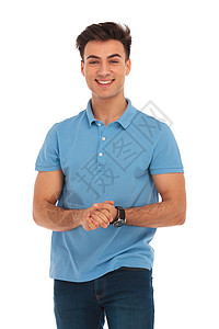穿着蓝衬衫的英俊青年男子触手而以孤立的演播室背景观看摄影机时拍手图片