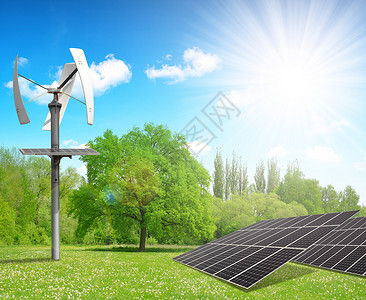 太阳能电池板和风力涡轮机在春季风景中图片