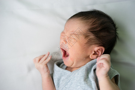 亚洲新生婴儿躺在床上哭泣图片