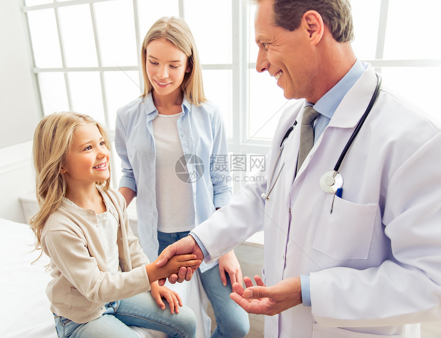 小女孩和她美丽的母亲在儿科医生那里咨询女孩微笑着与英俊的图片