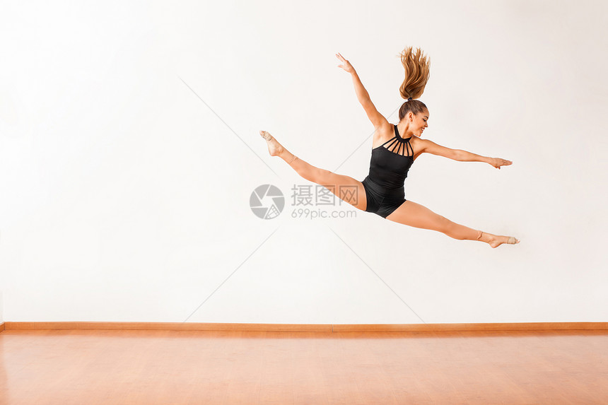 一位漂亮的西班牙裔女舞者在空中劈腿图片