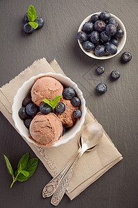 巧克力冰淇淋和蓝莓白碗黑板背图片