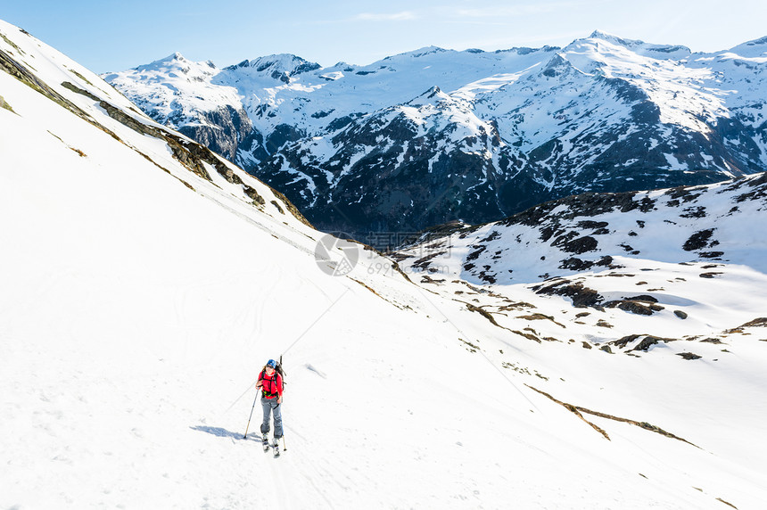 女滑雪者攀登山坡在奥地利马图片