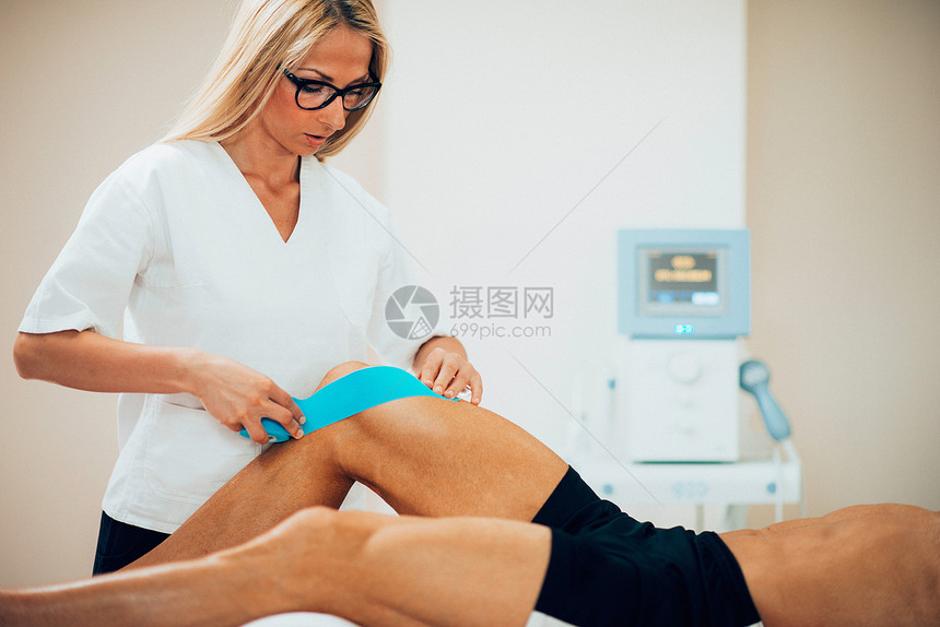 物理治疗师在病人膝上图片