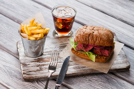 一桶薯条和三明治加冰饮用在美式餐厅享用美味佳肴美味的三明治配图片