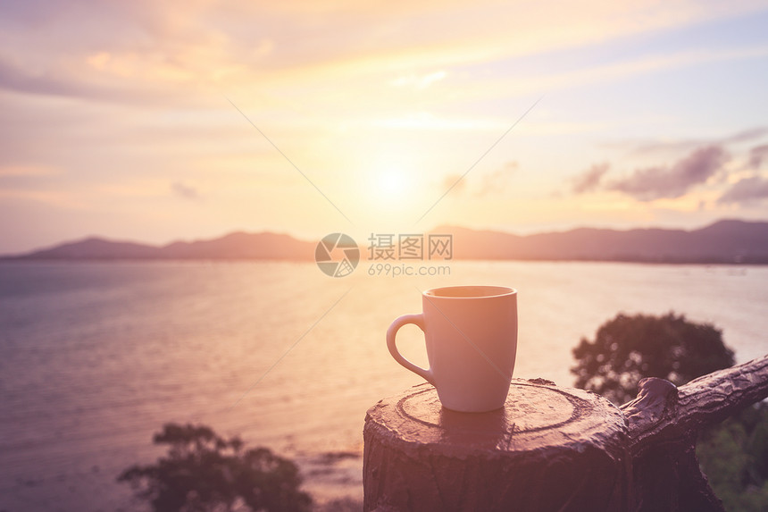 日落时关闭咖啡杯或日出沙滩图片