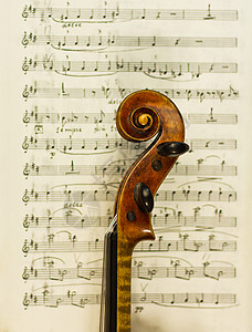 美丽的小提琴背景在旧笔记乐器弦图片