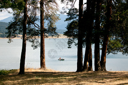 在高山湖上捕鱼的人和渔船图片