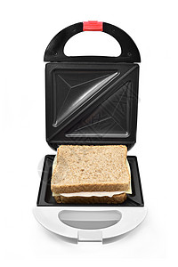 准备在电动三明治烤面包机中烤的三明图片