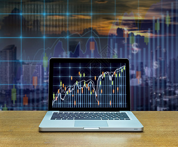 木桌上笔记本屏幕上的证券交易所市场交易图图片