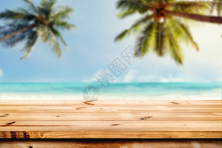 海面和椰子树背景模糊的顶层木桌空准备供您的产品显示时使用夏季海滩图片