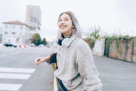 年轻美丽的白种人紫灰头发女人在城市户外散步图片