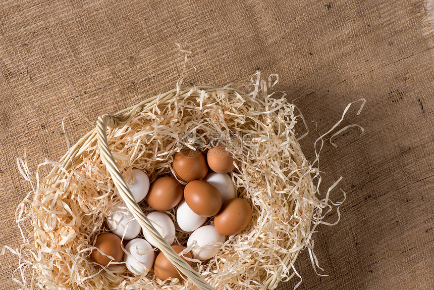 复活节时最美的白鸡蛋和棕鸡蛋在篮图片
