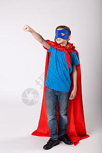 超人小孩举起手来假装飞翔穿着超级英图片