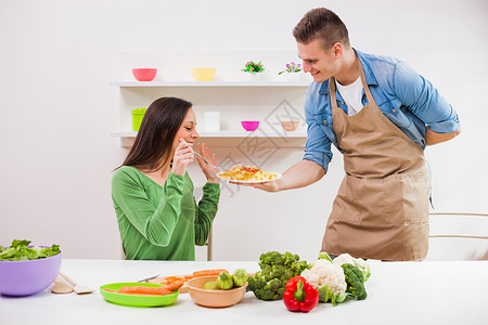 年轻夫妇在他们的做饭图片