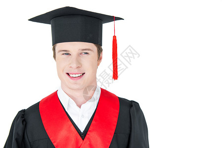 穿着学术礼服的快乐青年男子的肖像和在白色上微笑着微图片