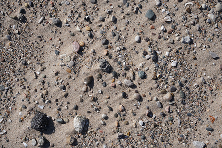 海滩水边的岩石沙土图片