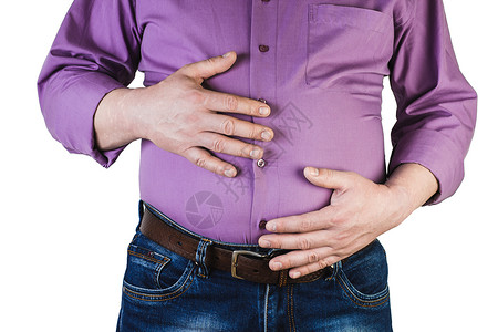 一个人用双手触摸胃部脂肪的体重过是肥胖的概念图片