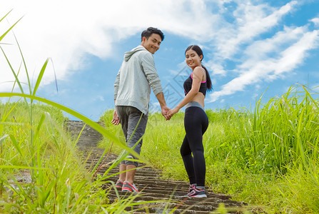 年轻夫妇在森林里跑上背景图片