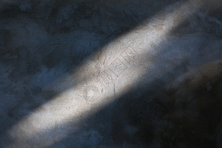 灰色水泥墙上的阳光特写图片