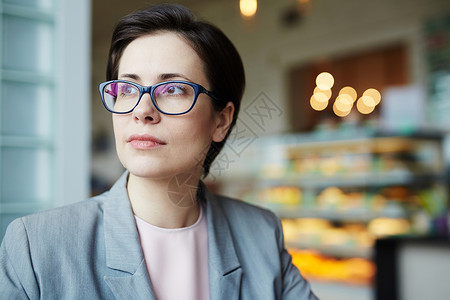 在咖啡馆休息的戴眼镜的女图片