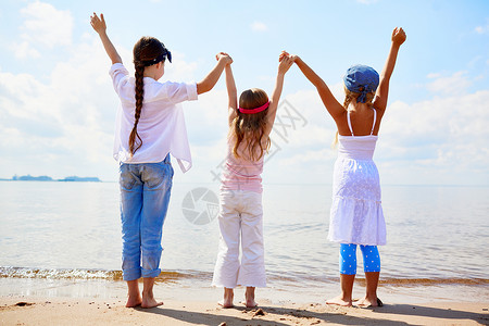 三名欣喜的女童背着眼神手牵在图片