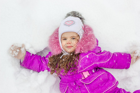 小女孩躺在雪地上图片